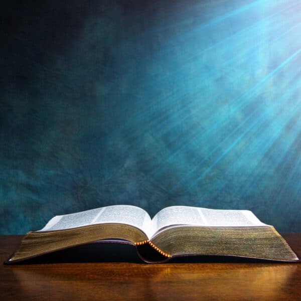 A bible opened up on a wood table