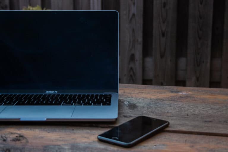 A laptop and phone on a table
