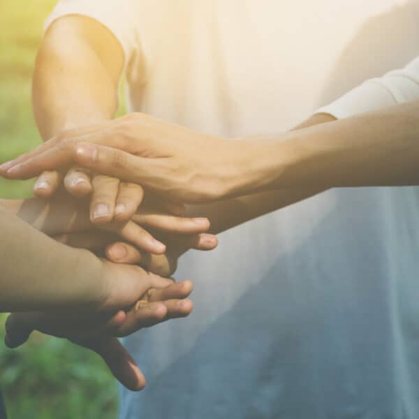 Small group of hands joining together