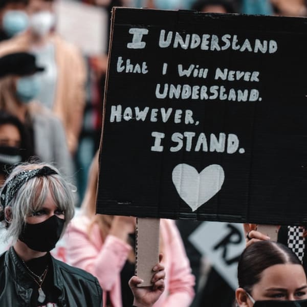 A woman peacefully protesting for racial and social justice