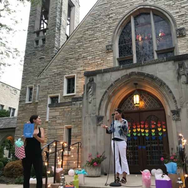 First Congo members reading children's books outside the church