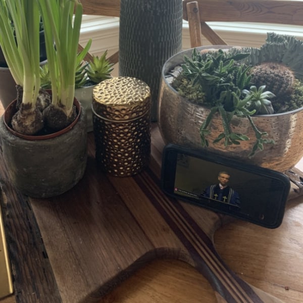 A phone on a table streaming a First Congo service