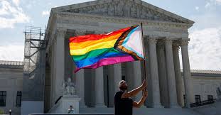 man waving pride flag